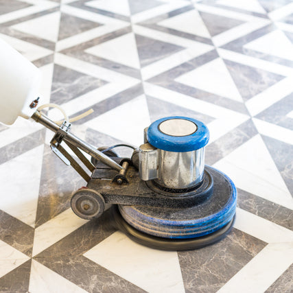 Floor EquipmentA floor polisher smoothing a geometric, black-and-white tiled floor. The blue and silver machine contrasts with the clean, polished tiles.